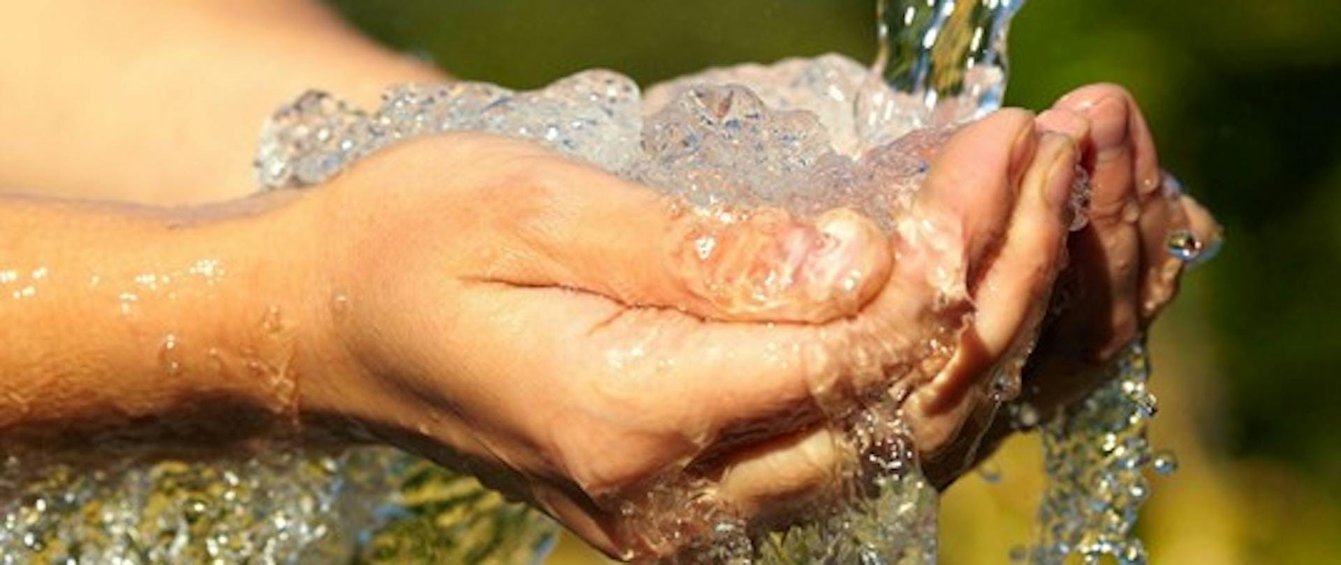 Clean Water and Healthy Living Photo of Hands Holding Clean Water